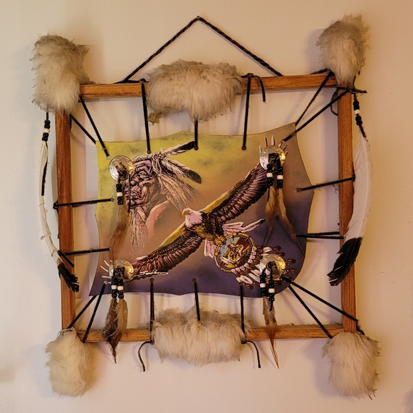 Native american art painted on hide with fur and feathers